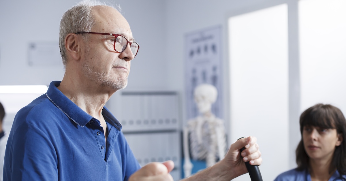 Shot of a young male physiotherapist helping a client with stretching exercises in his office during the day.